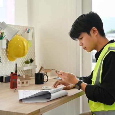 young-asian-man-working-on-the-design-of-a-constru-2024-11-29-02-04-19-utc.jpg